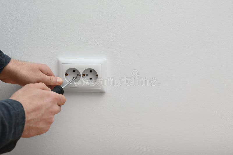Electrician Repairing Wall Sockets on White Background, Closeup. Stock