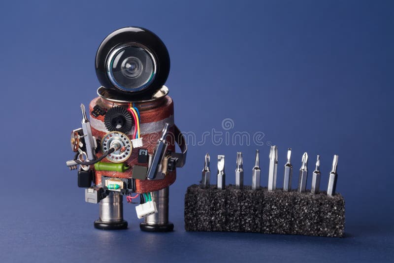 Electrician robot with screwdriver set. Fun service character, black helmet head and handyman instrument. Macro view royalty free stock image Electrician robot with screwdriver set. Fun service character, black helmet head and handyman instrument. Macro view royalty free stock image