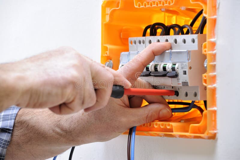 Electrician Technician at Work on a Residential Electric Panel Stock