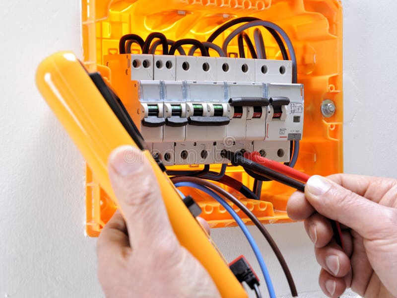 Electrician Technician at Work on a Residential Electric Panel Stock
