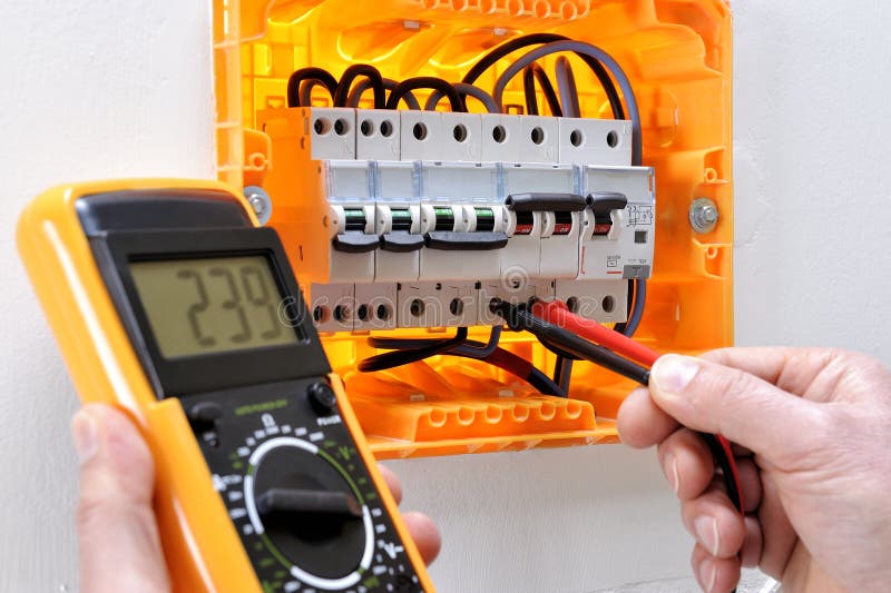 Electrician Technician at Work on a Residential Electric Panel Stock