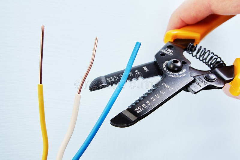 Electrician uses wire stripper cutter during electrical wiring s stock photo Electrician uses wire stripper cutter during electrical wiring s stock photo