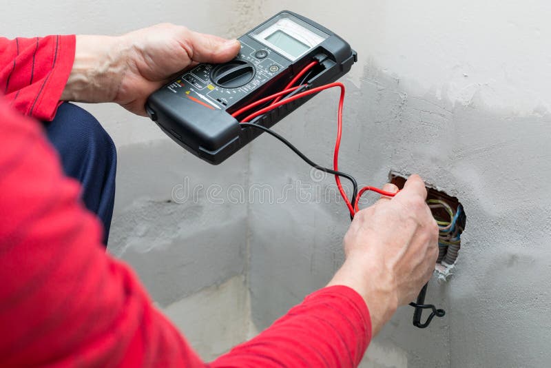Electrician using voltmeter when installing electric sockets on the wall in new home. Home electrician stock images, royalty-free photos and pictures