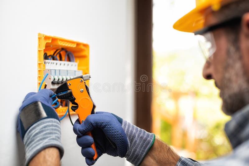 Electrician at Work with Safety Equipment on a Residential Electrical