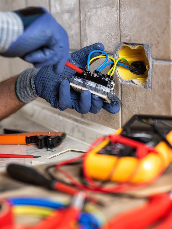 Electrician at Work with Safety Equipment on a Residential Electrical