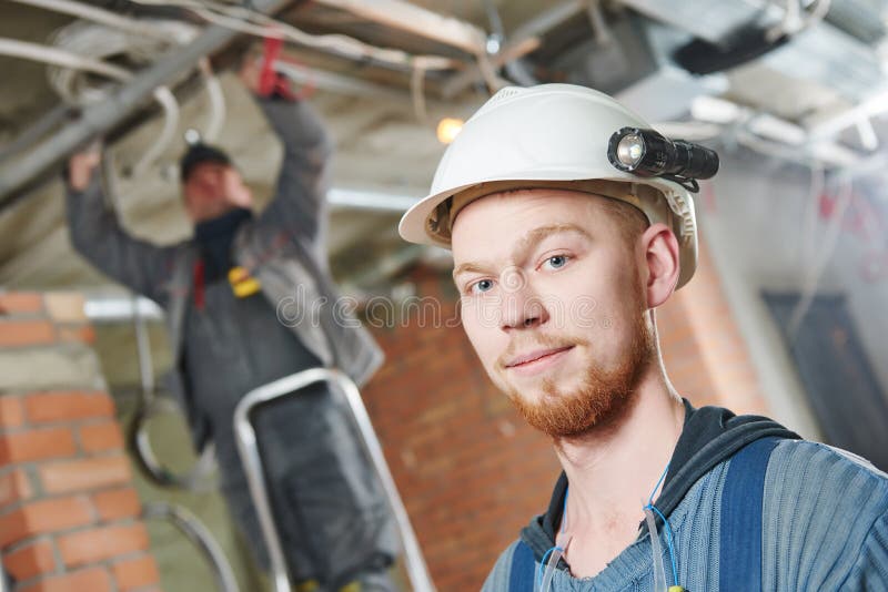 Electrician at Wiring with Working Drawings Stock Image Image of