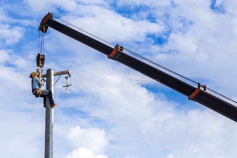 Electrician working on electric power pole