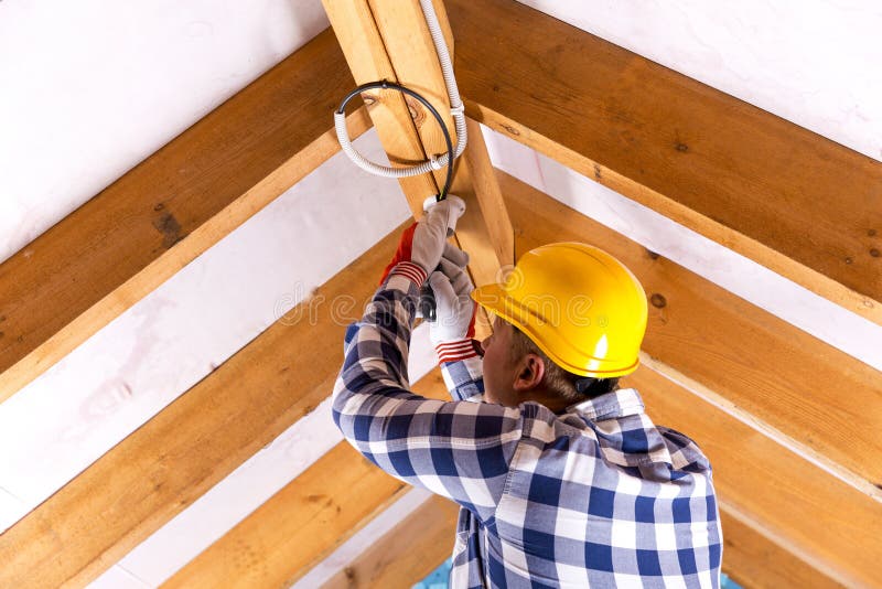 Electrician working with wires at attic renovation site royalty free stock photos Electrician working with wires at attic renovation site royalty free stock photos