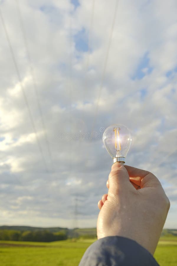 Electricity and Green Energy.Light Bulb in Hand .Alternative Natural