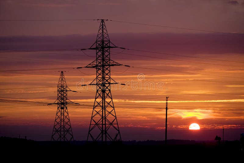 Electricity pylons near highway at sunset. Red pylons stock images, royalty-free photos and pictures