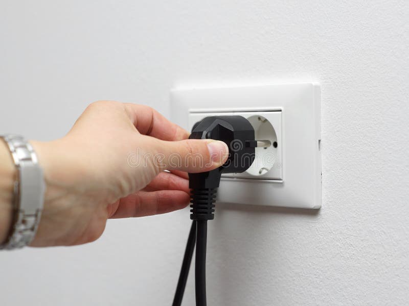 Electricity savings concept, woman unplugged plug stock photos