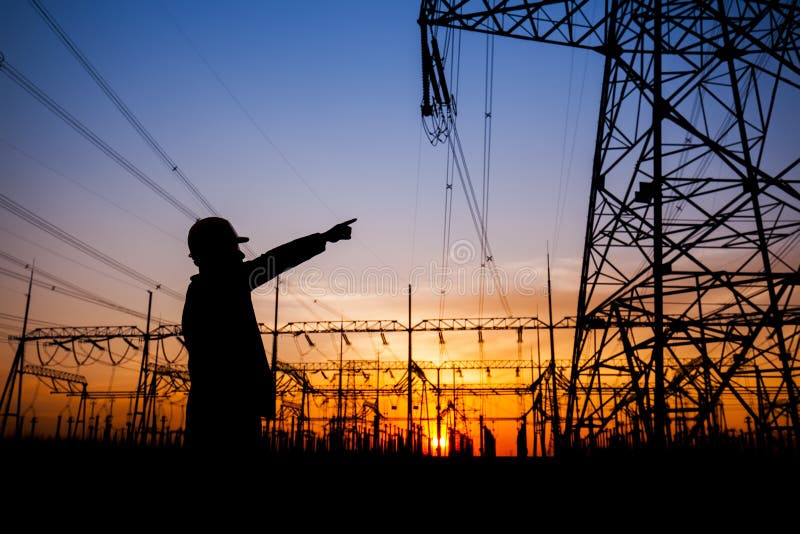 Electricity workers and pylon silhouette