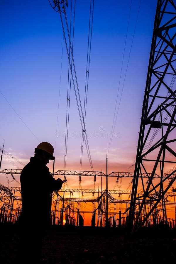 Electricity workers and pylon silhouette