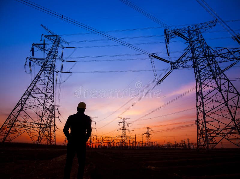 Electricity workers and pylon silhouette