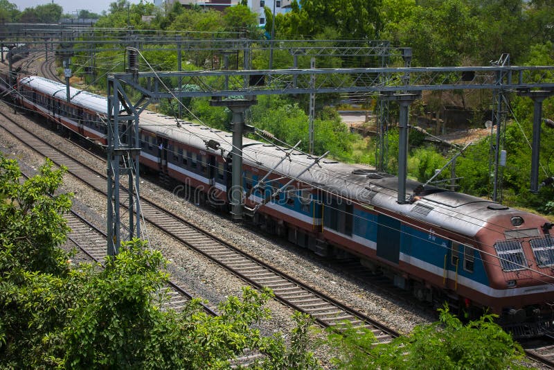 Electrified Railway Line of India with Multiple Tracks and Train a Closeup Shot Stock Photo