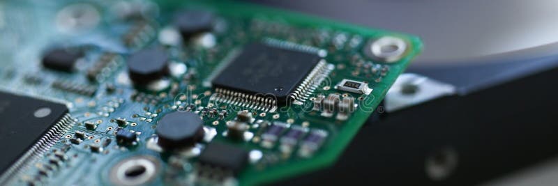 Electronic board with microchips on a hard drive background royalty free stock photo Electronic board with microchips on a hard drive background royalty free stock photo