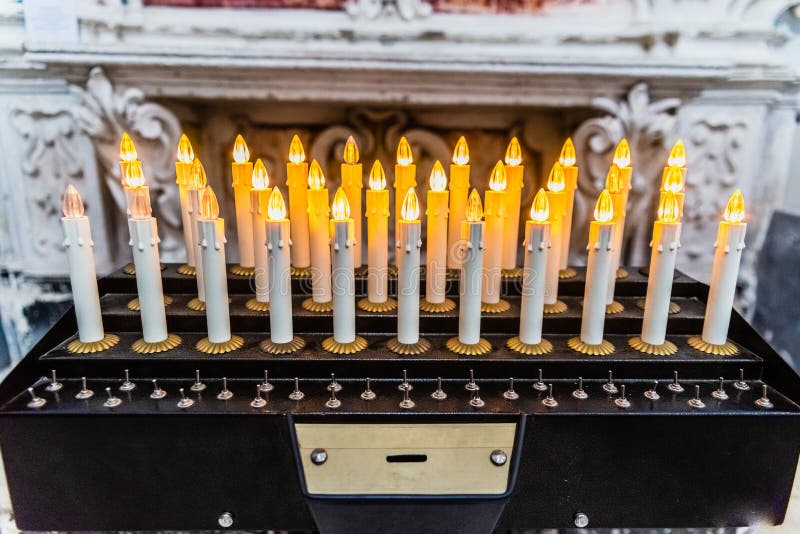 Electronic Candles with LEDs in a Church To Make an Offering of Alms
