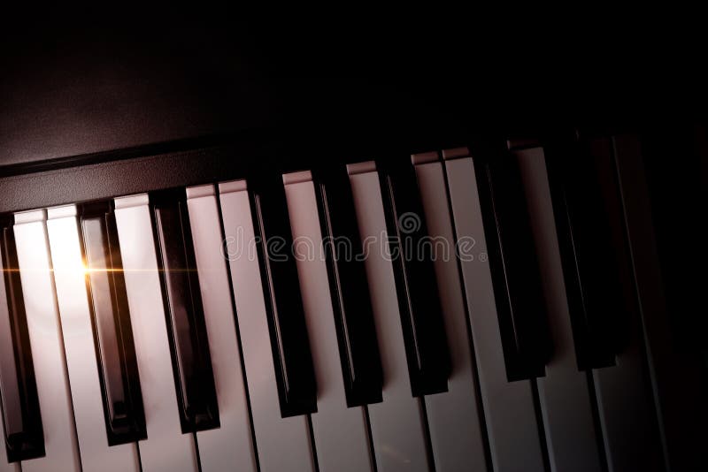 Electronic piano keyboard in the shade with shine top view