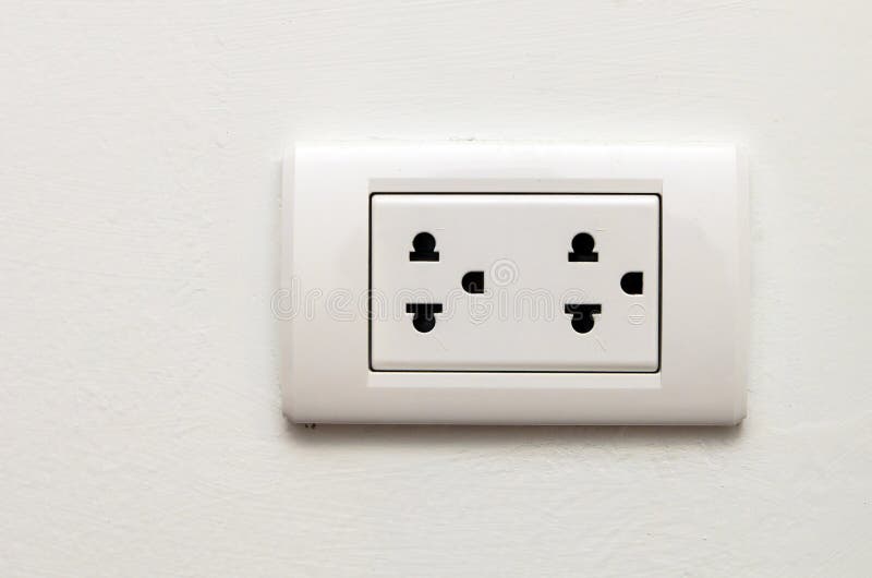Electronic socket on white wall stock photography