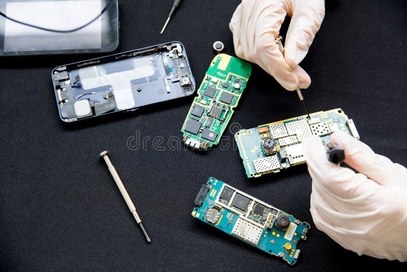 Electronics repair service - technician is fixing broken cell phone stock photography Electronics repair service - technician is fixing broken cell phone stock photography