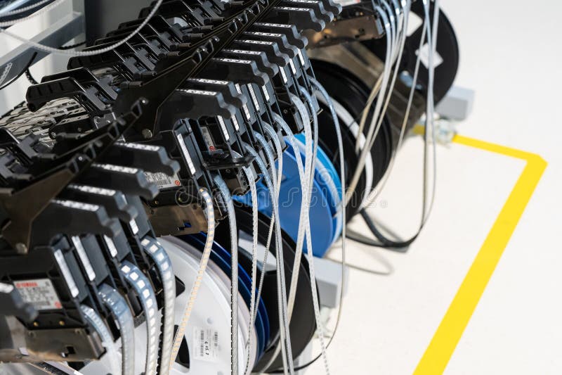 Electronics SMT reel components and feeders on the assembly line royalty free stock image