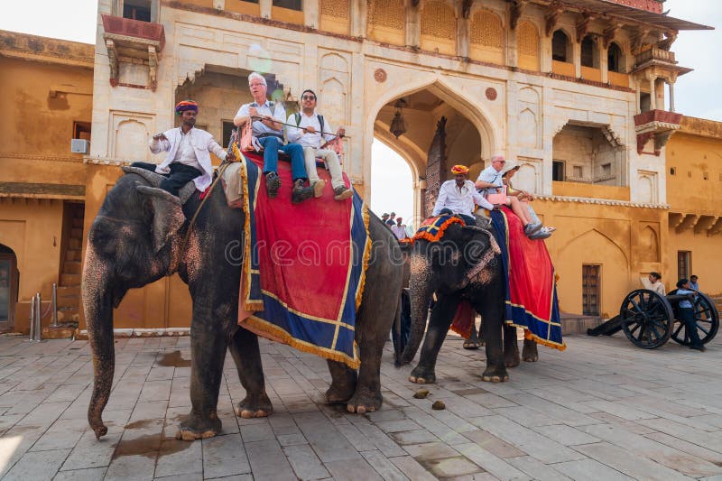 Elephants enter in the main courtyard in the Amber, Fort Amer , Rajasthan, India. A narrow 4WD road leads up to the entrance gate, known as the Suraj Pol (Sun Gate) of the fort. It is now considered much more ethical for tourists to take jeep rides up to the fort, instead of riding the elephants. Amer Fort or Amber Fort is a fort located in Amer, Rajasthan, India. Amer is a town with an area of 4 square kilometres (1.5 sq mi) located 11 kilometres (6.8 mi) from Jaipur, the capital of Rajasthan. Located high on a hill, it is the principal tourist attraction in Jaipur. Amer Fort is known for its artistic style elements. With its large ramparts and series of gates and cobbled paths, the fort overlooks Maota Lake which is the main source of water for the Amer Palace. Elephants enter in the main courtyard in the Amber, Fort Amer , Rajasthan, India. A narrow 4WD road leads up to the entrance gate, known as the Suraj Pol (Sun Gate) of the fort. It is now considered much more ethical for tourists to take jeep rides up to the fort, instead of riding the elephants. Amer Fort or Amber Fort is a fort located in Amer, Rajasthan, India. Amer is a town with an area of 4 square kilometres (1.5 sq mi) located 11 kilometres (6.8 mi) from Jaipur, the capital of Rajasthan. Located high on a hill, it is the principal tourist attraction in Jaipur. Amer Fort is known for its artistic style elements. With its large ramparts and series of gates and cobbled paths, the fort overlooks Maota Lake which is the main source of water for the Amer Palace.