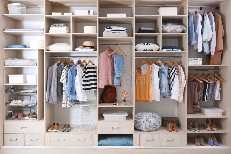 Stylish clothes, shoes and home stuff in large wardrobe closet. Stylish clothes, shoes and home stuff in large wardrobe closet