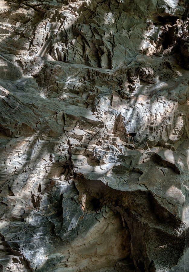Elegance of The intricate natural light and shadow on surface of stone wall stock image