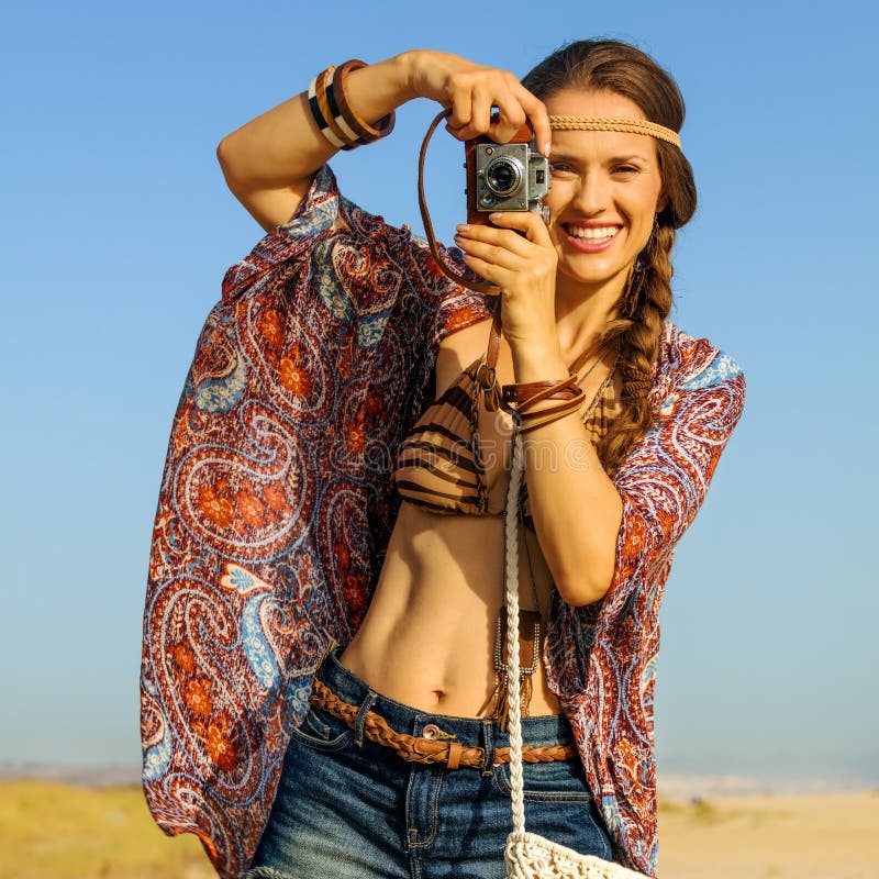 Elegancka gypsy stylu dziewczyna bierze fotografię z retro fotografii kamerą fotografia stock Elegancka gypsy stylu dziewczyna bierze fotografię z retro fotografii kamerą fotografia stock