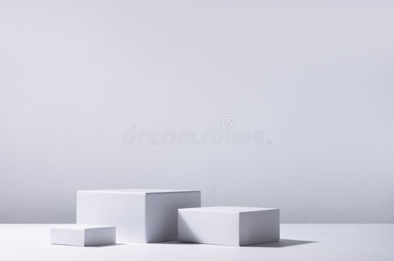 Elegant abstract set of white podiums in sunlight with shadow on white background for product display. Simple modern geometric. stock photo