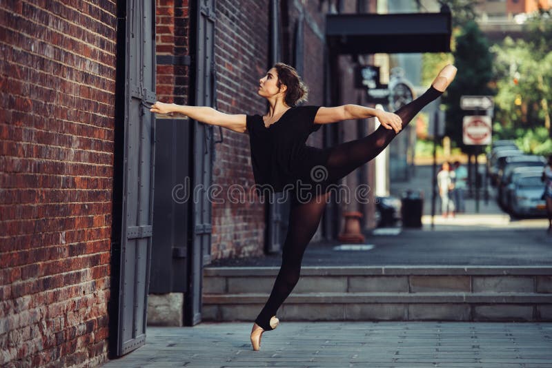 Elegant ballet dancer woman dancing ballet in the city stock photo Elegant ballet dancer woman dancing ballet in the city stock photo