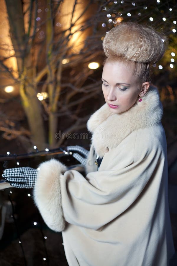 Elegant blond woman in retro style on a fall evening outdoors