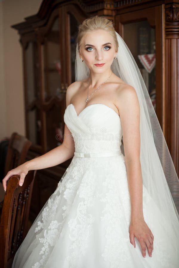 149 Elegant Blonde Bride White Wedding Dress Posing Hotel Room Stock