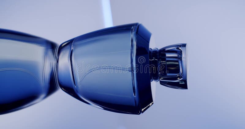 Elegant Blue Perfume Bottle on Reflective Surface with Soft Lighting stock video