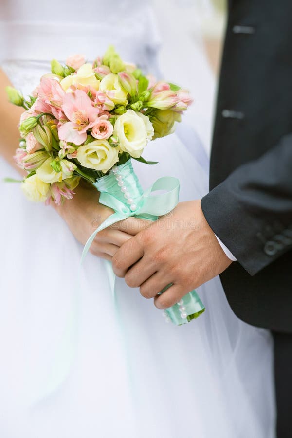 Elegant bride and groom holding beautiful wedding bouquet posing together royalty free stock photo Elegant bride and groom holding beautiful wedding bouquet posing together royalty free stock photo