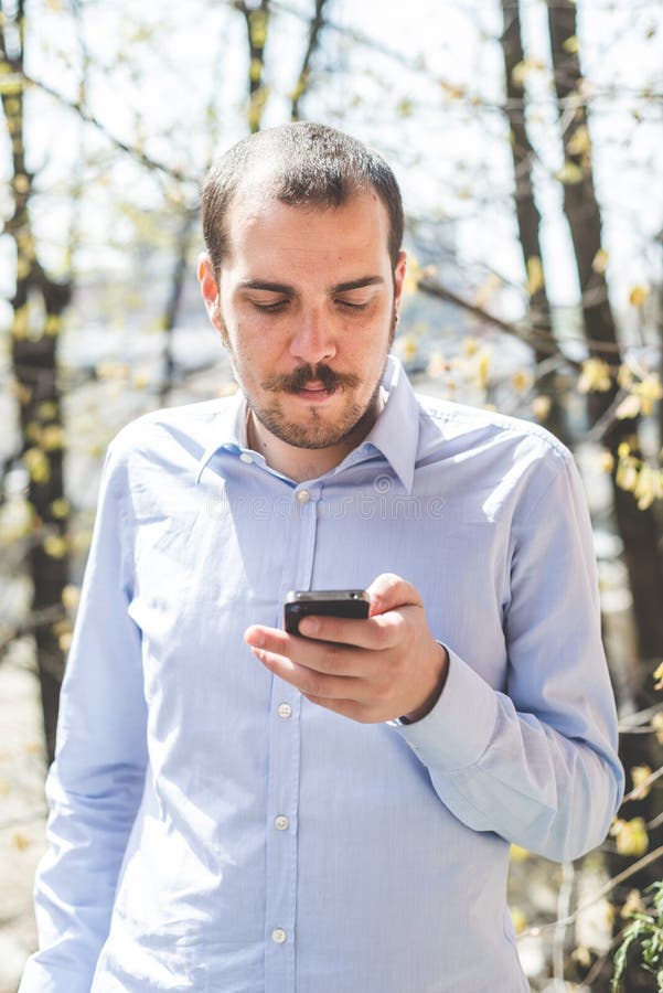 Elegant Business Multitasking Multimedia Man Calling with Smartphone