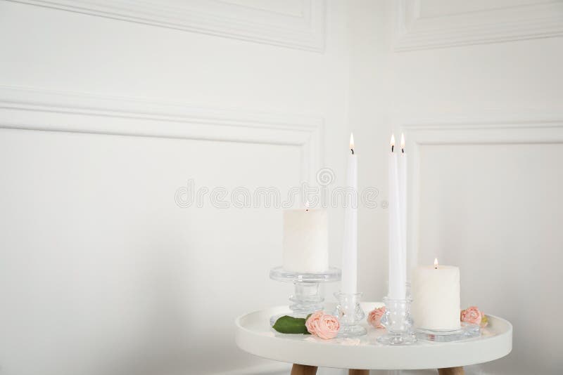 Elegant Candlesticks with Burning Candles on Light Table Stock Image