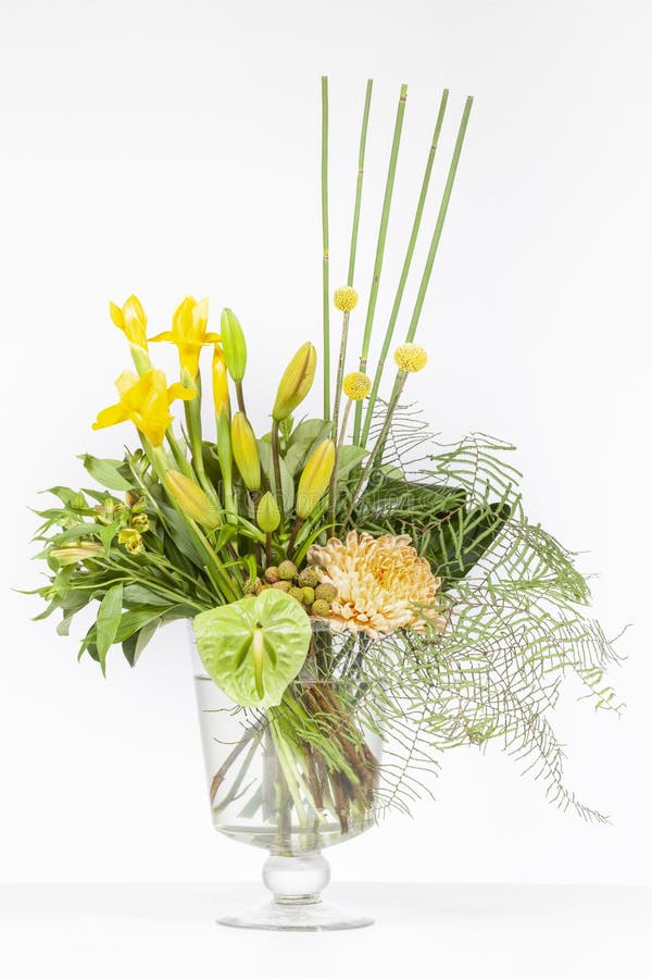 Elegant flower arrangement in beautiful vase isolated in a bright white studio