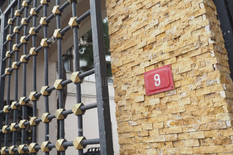 An Elegant Gate Design Complemented by a Number 9 House Sign Display royalty free stock photos