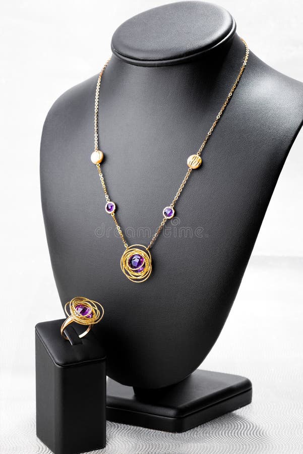 Elegant gold jewelry set with purple gemstones. stock photography