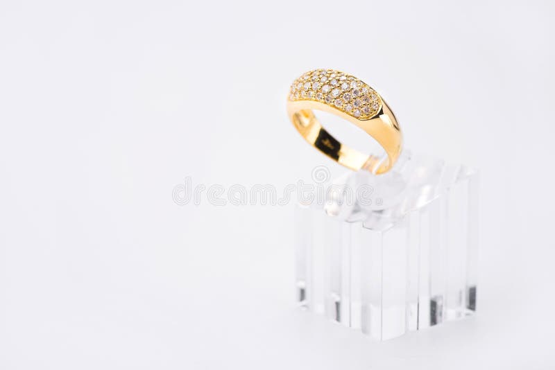 Elegant gold ring on acrylic stand. royalty free stock photos