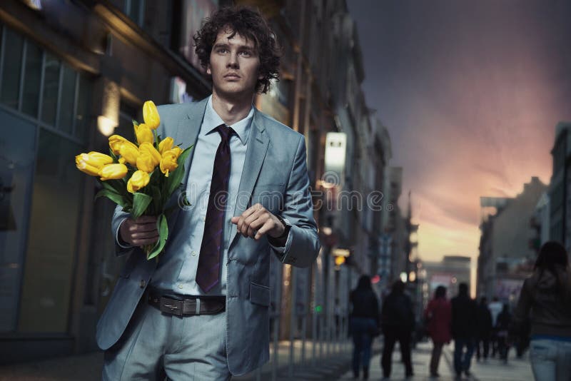 Elegant man holding flowers