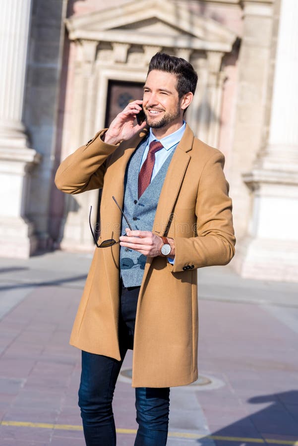 An Elegant Man Standing on a Square and Talking on His Phone Stock ...