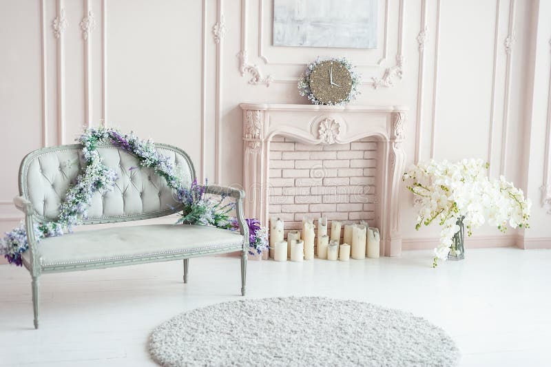 Elegant pink pastel fireplace decorated with spring flowers, candles. Rose room with sofa, flowers. Wedding area. Vintage provence decor in bright interior, design, home, wall, furniture, apartment, light, comfortable, wooden, style, white, space, cozy, beige, lounge, elegance, horizontal, chic, relaxation, luminosity, divan, couch, decorative, classic, drawing, empty, fresh, hotel, leisure, lifestyle, living, luxury, colors, retro, romance, salon, stylish