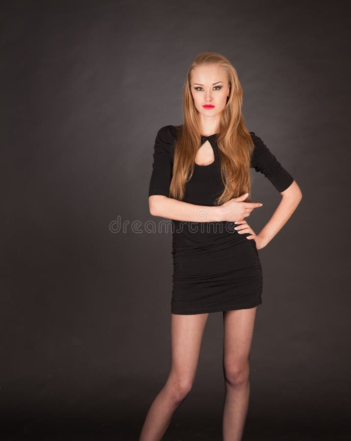 Elegant posing young blond girl stock photo