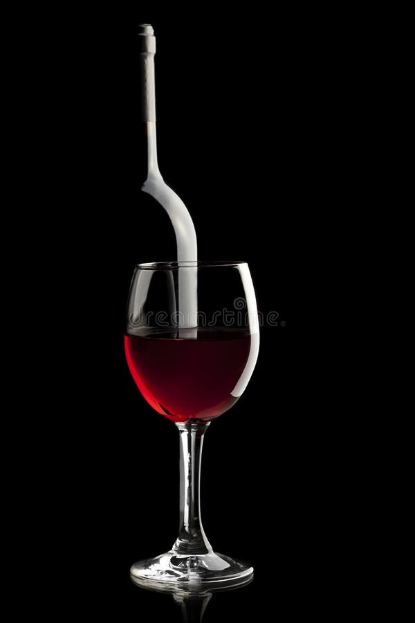 Elegant red wine glass and a wine bottle in black background. Elegant red wine glass and a wine bottle in black background