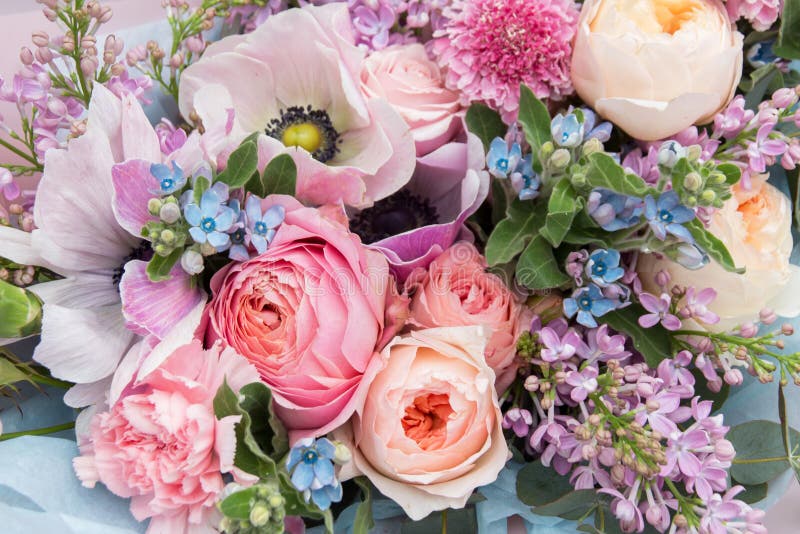 Beautiful elegant soft wedding pink blue bouquet with roses and lilac flowers closeup. Floral background. Beautiful elegant soft wedding pink blue bouquet with roses and lilac flowers closeup. Floral background