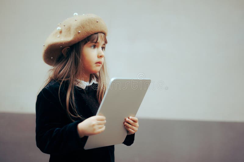 Elegant Toddler Girl Holding a Pc Tablet for Leaning royalty free stock photos