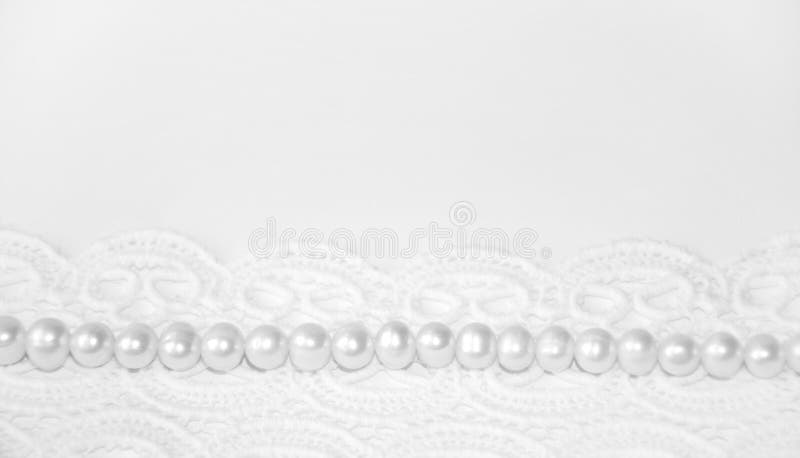 Elegant white background with lace and pearls