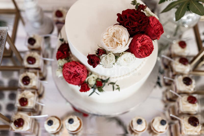 Elegant White Wedding Cake with Fresh Roses on Top Stock Photo Image
